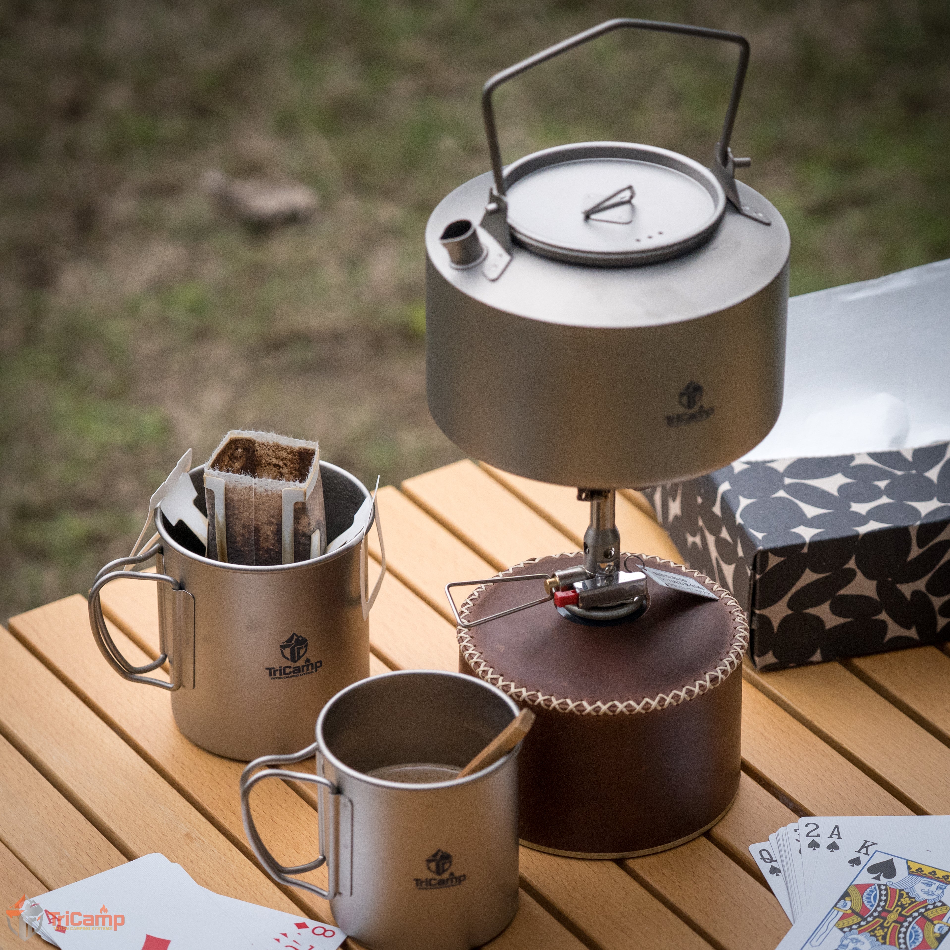TriCamp Titanium Mug with Lid lifestyle — in use outdoors on a camping trip