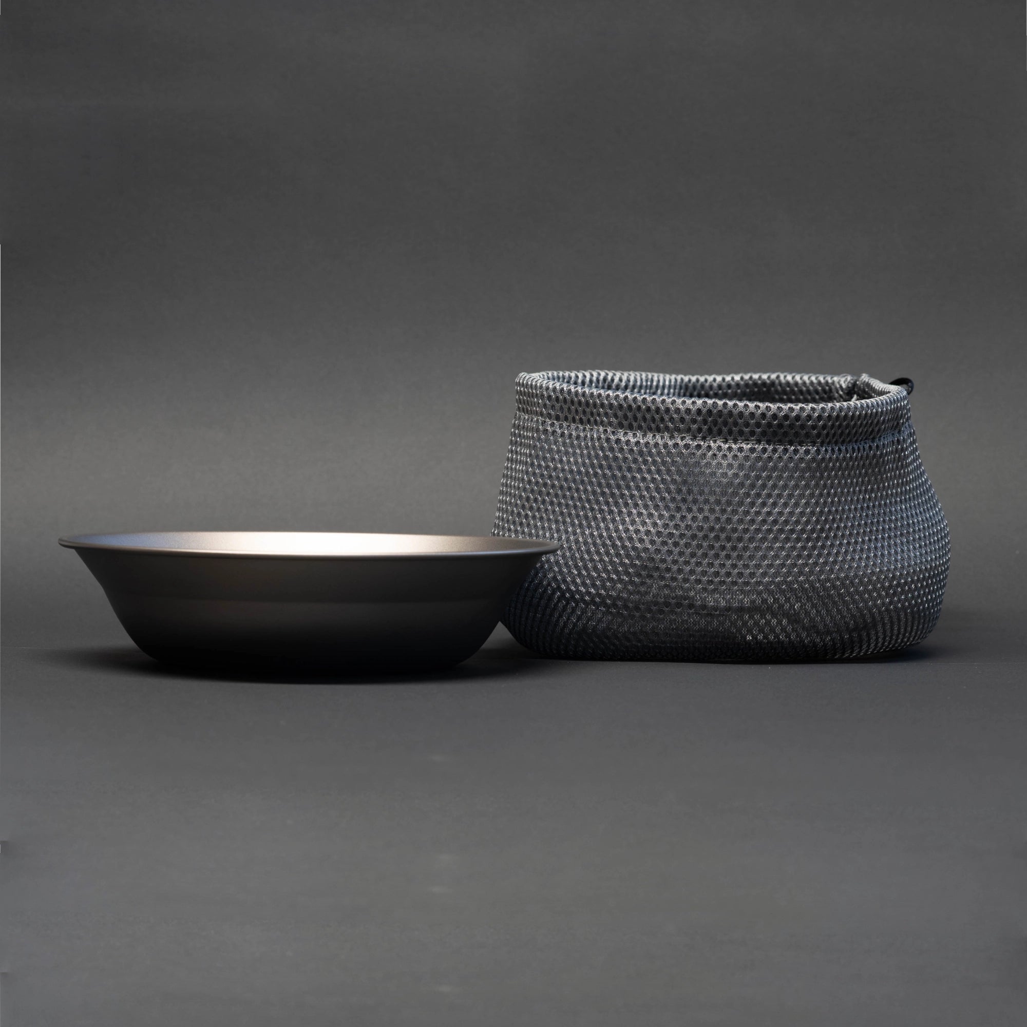 TriCamp Titanium Plate 750ml in use — serving a camping meal outdoors at trail